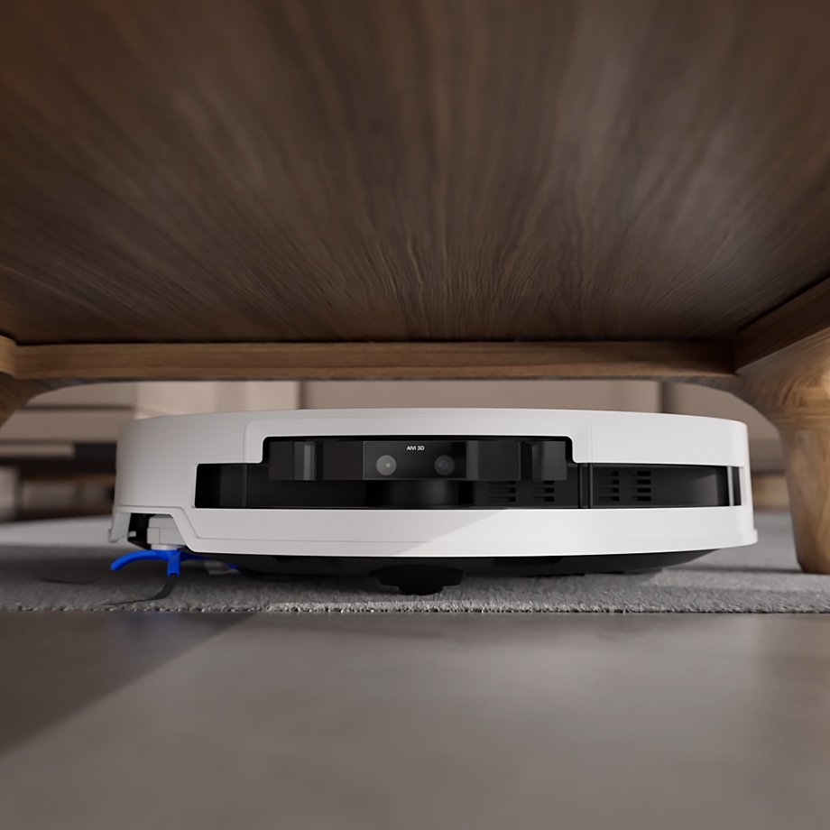 White ECOVACS DEEBOT T50 PRO OMNI sliding under a low wooden bench, manufacturer still, no people